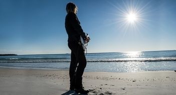 Man plays guitar on the beach