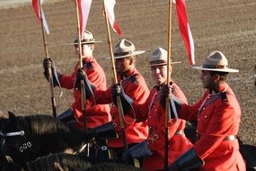 Mounted Canadian Policemen with flags