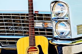 guitar near vintage cars