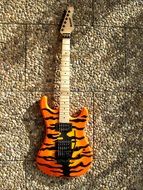 painted electric guitar on a wall