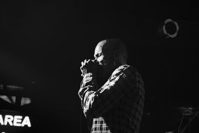 singer on stage in black and white image