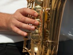 male hand on brass Musical Instrument