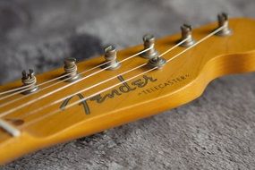strings of the yellow guitar close up