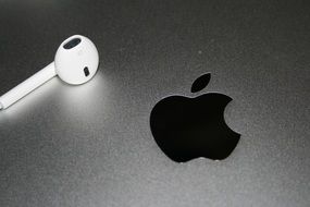 headphones on laptop with apple logo