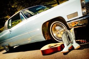 silver cowboy boots, guitar and vintage car