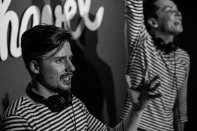 Black and white photo of music djs on the concert