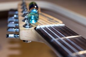 fretboard with strings on an electric guitar