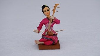 toy thai girl with musical instrument