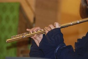 Human playing on a flute