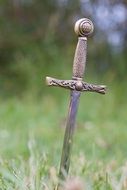 sharp dagger in green grass close-up