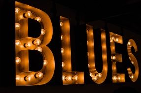 word "blues" in bright light