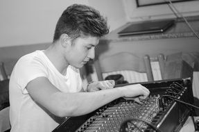 young man works in a recording studio