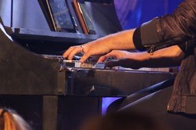 man playing the piano at a concert