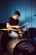 man sitting at the drum kit