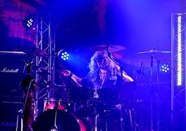 drummer at a concert in blue lights