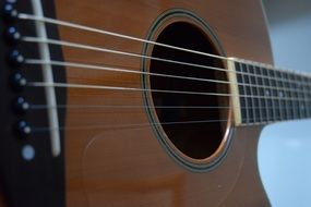 Strings on the wooden acoustic guitar