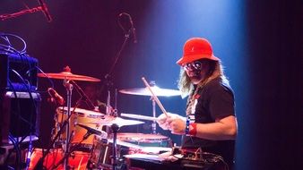 drummer in red hat on stage