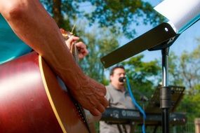 guitar in the hands of a street musician close up