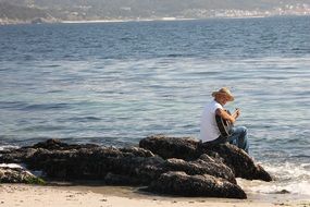 guitarist at the seaside on a sunny day