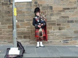 Street Artist in kilt plays bagpipes, uk, scotland, edinburgh