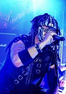 rock singer on a bright blue stage