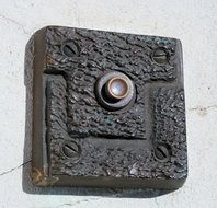 metal doorbell on the wall