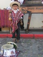 child with maracas on a street in Guatemala