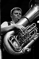 Black and white photo of playing musician on a tuba