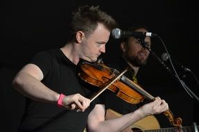 man playing violin at celtic festival