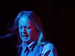 musician on stage in the dark