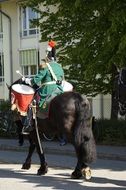 traditional guard with a drum on a horse