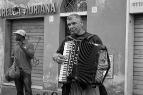 mature man plays Accordion on street, Italy, Rome