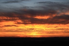 Dark sunset in the cloudy sky