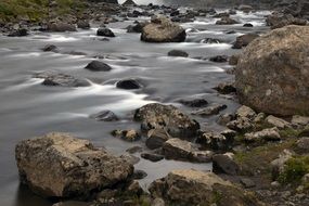 Landscape with the stones in the water of waterfall