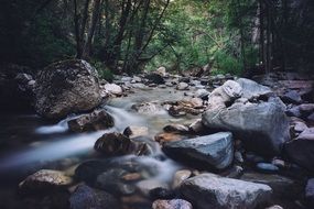 little fog over a rocky mountain stream