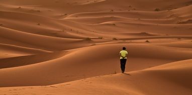 person on Red sand Dunes, morocco, sahara desert