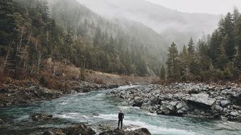 man near a mountain river among the beautiful and colorful nature