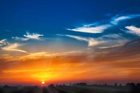 Beautiful, bright and colorful sunset over the valley on beautiful landscape