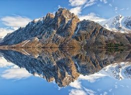 mirror reflection of mighty mountains in a pond in Norway