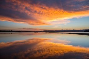 yellow clouds reflected in Yellowstone Lake