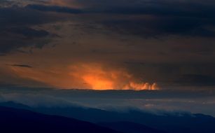 thick clouds and bright sun over the mountains