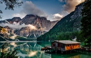 pier on a lake near mountains in italy