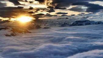 sun behind clouds in winter in austria