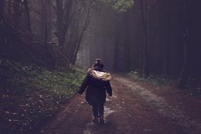 little girl on a forest road