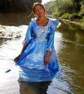 Girl Princess in blue dress in the lake