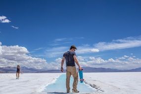 man with a pennyboard in salt marshes