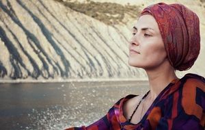 beautiful girl in a red scarf near the water