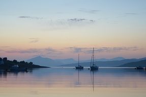 boats on water during sunset in scotland