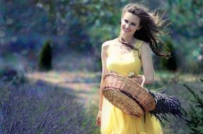 girl in a yellow dress with a basket of flowers
