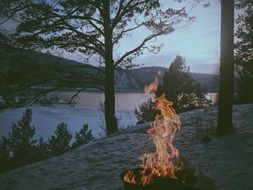 campfire Lake in forest on River bank